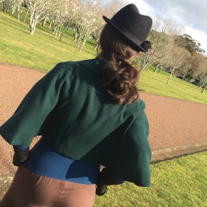 green cape standing back