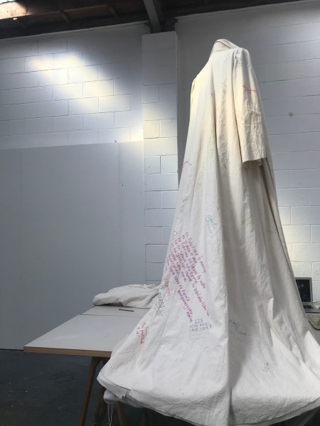 Unbound coat working on the hem on the table beautiful Low res