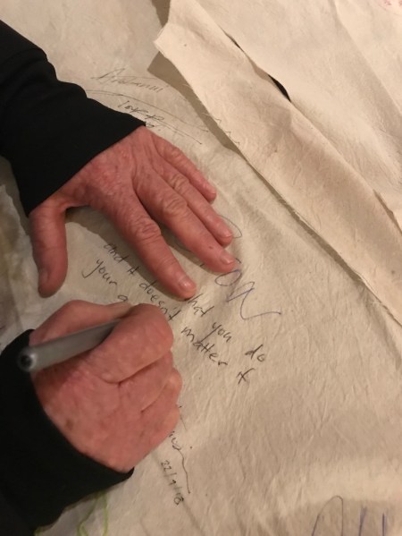 Woman's hands signing the cloth