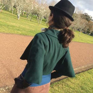 green cape standing back 3